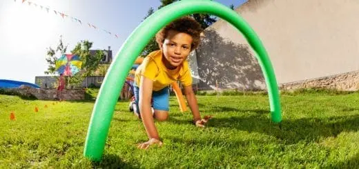 Kids crawl under course of barriers on his fours
